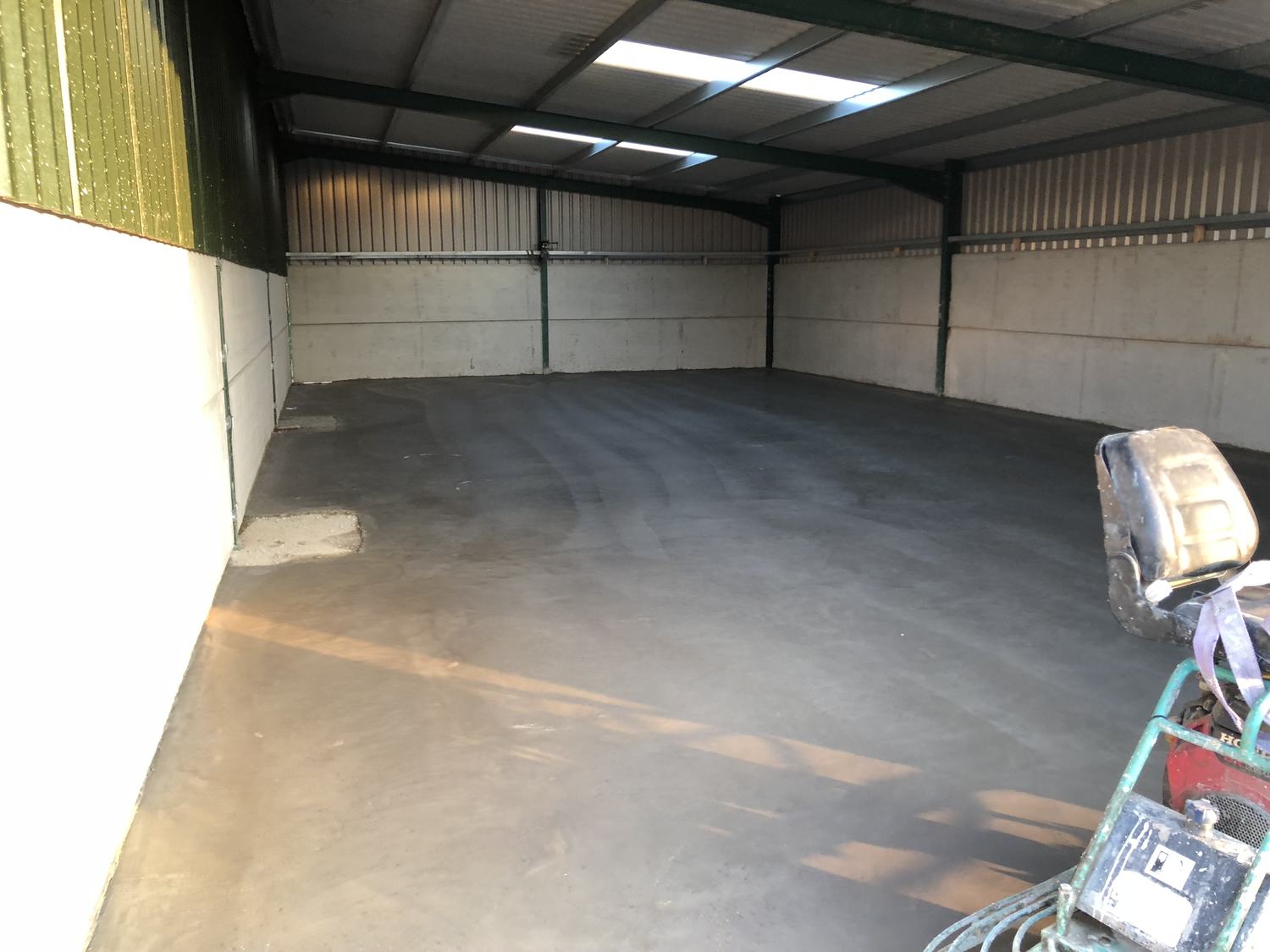 New concrete floor inside a portal frame building